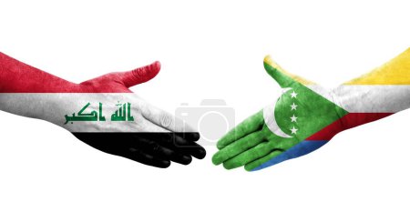 Photo for Handshake between Comoros and Iraq flags painted on hands, isolated transparent image. - Royalty Free Image