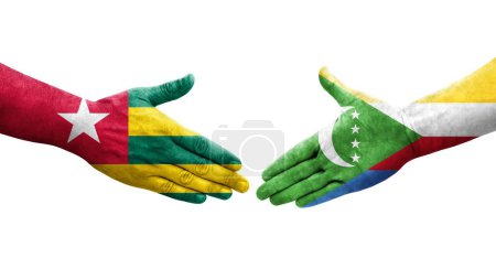 Photo for Handshake between Comoros and Togo flags painted on hands, isolated transparent image. - Royalty Free Image