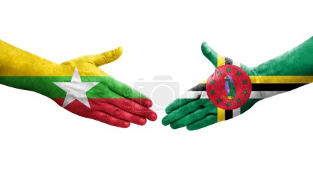 Foto de Apretón de manos entre Dominica y Myanmar banderas pintadas en las manos, imagen transparente aislada. - Imagen libre de derechos