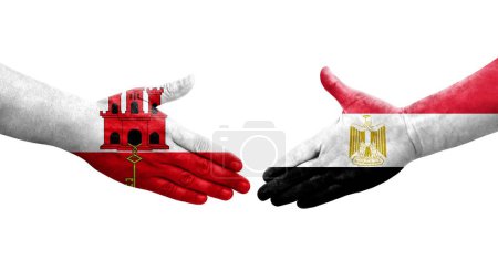 Foto de Apretón de manos entre Egipto y Gibraltar banderas pintadas en las manos, imagen transparente aislada. - Imagen libre de derechos