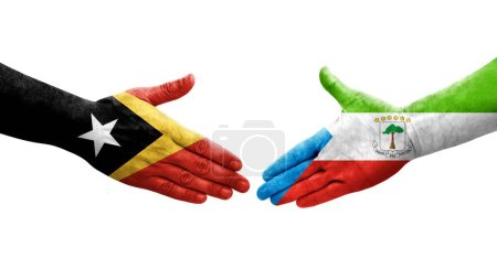 Poignée de main entre les drapeaux de Guinée équatoriale et du Timor oriental peints sur les mains, image transparente isolée.