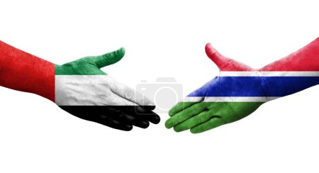 Foto de Apretón de manos entre las banderas de Gambia y Emiratos Árabes Unidos pintadas en las manos, imagen transparente aislada. - Imagen libre de derechos