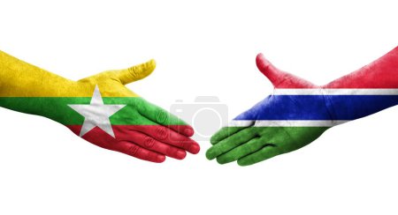 Foto de Apretón de manos entre las banderas de Gambia y Myanmar pintadas en las manos, imagen transparente aislada. - Imagen libre de derechos