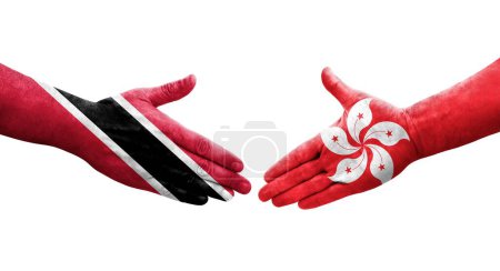 Téléchargez les photos : Poignée de main entre les drapeaux de Hong Kong et Trinité Tobago peints sur les mains, image transparente isolée. - en image libre de droit