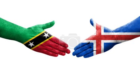 Photo for Handshake between Iceland and Saint Kitts and Nevis flags painted on hands, isolated transparent image. - Royalty Free Image