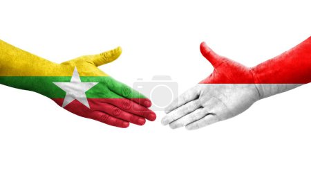 Foto de Apretón de manos entre Indonesia y Myanmar banderas pintadas en las manos, imagen transparente aislada. - Imagen libre de derechos