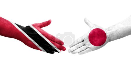 Téléchargez les photos : Poignée de main entre le Japon et Trinité Tobago drapeaux peints sur les mains, image transparente isolée. - en image libre de droit