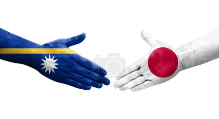 Handshake between Japan and Nauru flags painted on hands, isolated transparent image.