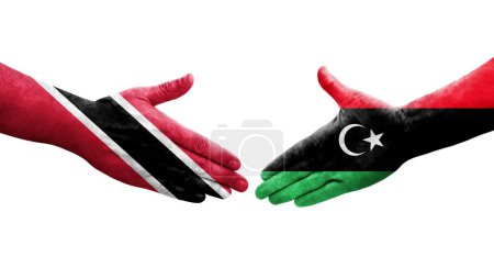 Téléchargez les photos : Poignée de main entre la Libye et Trinité Tobago drapeaux peints sur les mains, image transparente isolée. - en image libre de droit