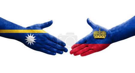 Photo for Handshake between Liechtenstein and Nauru flags painted on hands, isolated transparent image. - Royalty Free Image