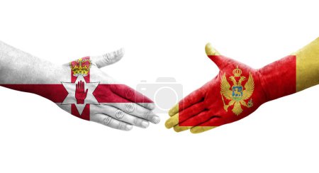 Photo for Handshake between Montenegro and Northern Ireland flags painted on hands, isolated transparent image. - Royalty Free Image