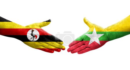 Foto de Apretón de manos entre Myanmar y Uganda banderas pintadas en las manos, imagen transparente aislada. - Imagen libre de derechos