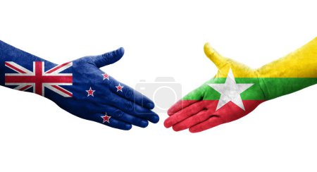 Foto de Apretón de manos entre Myanmar y Nueva Zelanda banderas pintadas en las manos, imagen transparente aislada. - Imagen libre de derechos