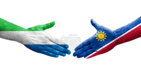 Handshake between Namibia and Sierra Leone flags painted on hands, isolated transparent image.