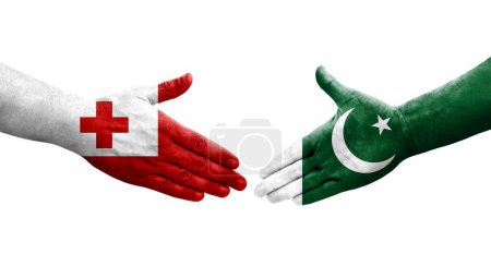 Photo for Handshake between Pakistan and Tonga flags painted on hands, isolated transparent image. - Royalty Free Image