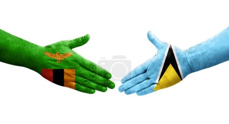 Photo for Handshake between Saint Lucia and Zambia flags painted on hands, isolated transparent image. - Royalty Free Image