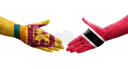 Téléchargez les photos : Poignée de main entre Sri Lanka et Trinité Tobago drapeaux peints sur les mains, image transparente isolée. - en image libre de droit