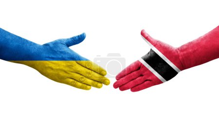 Téléchargez les photos : Poignée de main entre Trinité Tobago et l'Ukraine drapeaux peints sur les mains, image transparente isolée. - en image libre de droit