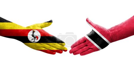 Téléchargez les photos : Poignée de main entre Trinité Tobago et l'Ouganda drapeaux peints sur les mains, image transparente isolée. - en image libre de droit