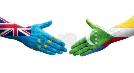 Photo for Handshake between Tuvalu and Comoros flags painted on hands, isolated transparent image. - Royalty Free Image