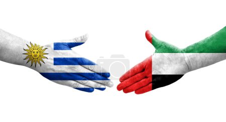 Foto de Apretón de manos entre los Emiratos Árabes Unidos y Uruguay banderas pintadas en las manos, imagen transparente aislada. - Imagen libre de derechos