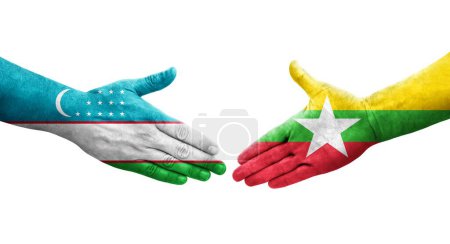 Foto de Apretón de manos entre Uzbekistán y Myanmar banderas pintadas en las manos, imagen transparente aislada. - Imagen libre de derechos