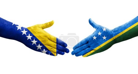 Handshake between Solomon Islands and Bosnia flags painted on hands, isolated transparent image.