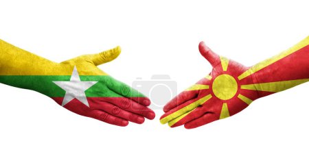 Foto de Apretón de manos entre Macedonia del Norte y Myanmar banderas pintadas en las manos, imagen transparente aislada. - Imagen libre de derechos