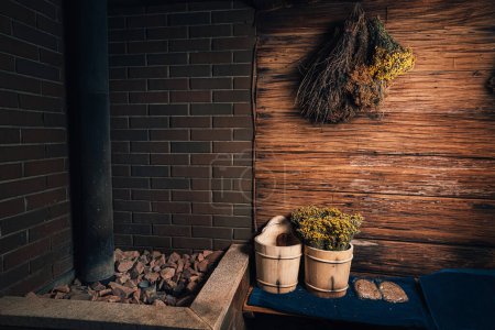 Photo for Spa, sauna with stones and wellness center with water bucket, oak brooms, herbs on wooden background. winter wellness concept relaxing and healing therapy. - Royalty Free Image