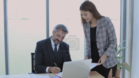 Photo for Business concept of 4k Resolution. The secretary is bringing the document to the manager to sign in the office. Man putting signature on papers. - Royalty Free Image