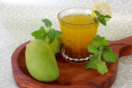 Téléchargez les photos : Aam Panna ina verre sur plateau en bois avec citron et menthe - en image libre de droit