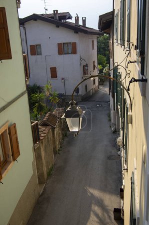 Photo for Varignano, Arco, Italy - June 2, 2022: Amazing narrow streets whit old mountain houses, way of living in italian Alps - Royalty Free Image