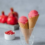 Two scoop creamy pomegranate ice cream cone. Healthy vegan desserts. High quality photo