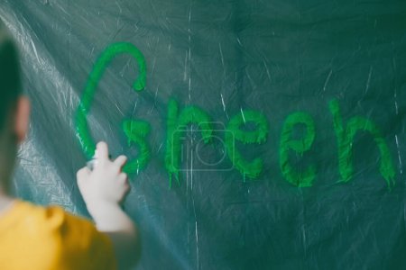 Photo for Graffiti Graffiti Green sprayed with green paint on polythene. Deceptive marketing of an ecological product, services or company, brands. High quality photo - Royalty Free Image