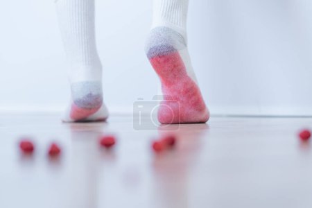 Photo for Dirty berries stains on white clothes. An unrecognizable person stepping on the dirty floor and soiled his white socks. daily life stain concept. High quality photo - Royalty Free Image