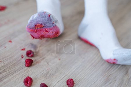 Photo for Crushing the berry underfoot. A dirty berry stain on the footprint of a white sock. daily life stain concept. - Royalty Free Image