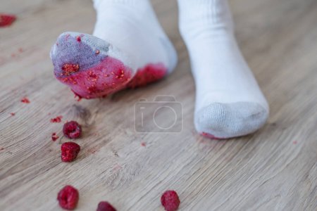 Photo for Crushing the berry underfoot. A dirty berry stain on the footprint of a white sock. daily life stain concept. - Royalty Free Image