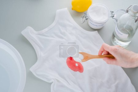 Dirty blood stains or wine on clothes. The concept of organic removing stains on clothes with baking soda. Zero waste concept. top view. High quality photo