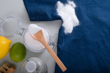 Photo for Homemade cleaning sweat stains the armpits on a T-shirt. Eco-friendly cleaning products white vinegar, baking soda, lemon. Embracing a zero-waste lifestyle. High quality photo - Royalty Free Image