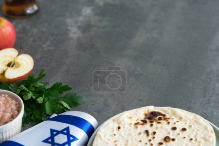 Handmade round Matzah in a plate on a concrete background. Saved Jewish Pesach Tradition. Jewish Passover celebrations. space for text. High quality photo