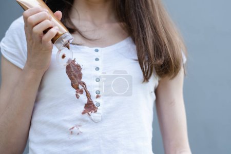 Dirty stain of spilled cosmetic cream on a white clothes. Liquid tanning or foundation cream. daily life stain and cleaning concept. . High quality photo