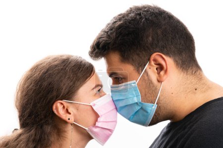 Photo for Close-up of female male couple wearing pink and blue medical or surgical protective dace masks to prevent infection with sars covid19 virus isolated on white background - Royalty Free Image