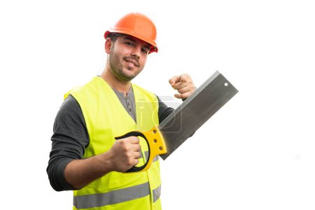Photo for Male constructor with friendly cheerful expression pointing index finger at lumber saw isolated on white studio background - Royalty Free Image