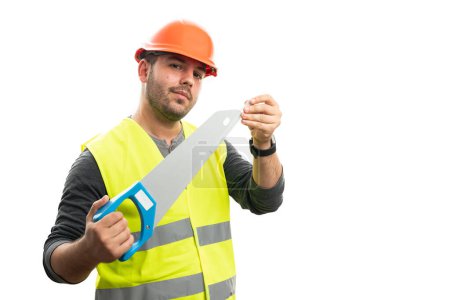 Photo for Adult male constructor wearing fluorescent vest and orange hardhat covering saw blade with blank copyspace isolated on white studio background - Royalty Free Image