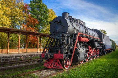 Photo for Railway Museum in the town of Haapsalu. In the foreground is the old locomotive and the train station. Scene photographed in the autumn season. Estonia. - Royalty Free Image