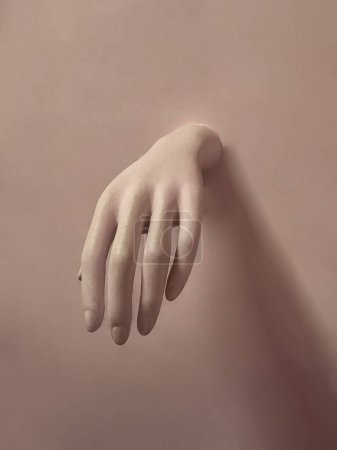 Mannequin hand on a pink background. Space for text.