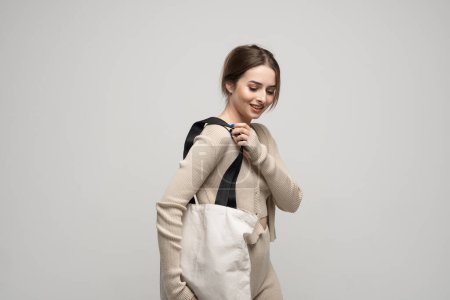 Photo for Young woman with cotton bag in her hands. Concept of recycle for better environment. No plastic - Royalty Free Image