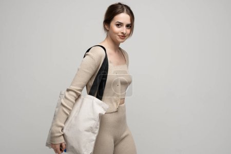 Photo for Young woman with cotton bag in her hands. Concept of recycle for better environment. No plastic - Royalty Free Image