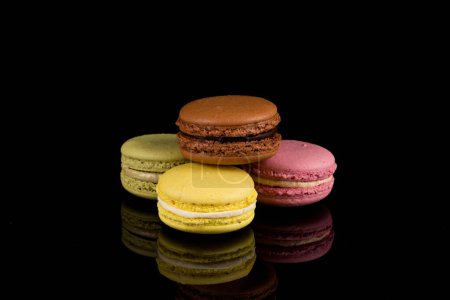 Photo for Colorful macaroons over a black background with reflection - Royalty Free Image