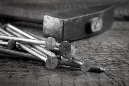 Photo for Vintage old hammer with rusty nails on wood table background - Royalty Free Image